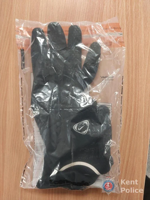 Black gloves sealed in a clear plastic evidence bag, with Kent Police branding.