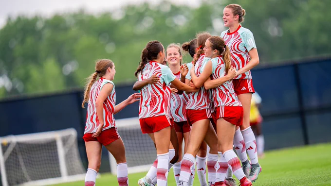 Teal Rising Elite Cup participants celebrating after scoring a goal 