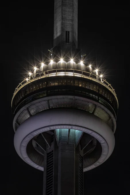 Closeup of the CN Tower at night with the lights dimmed