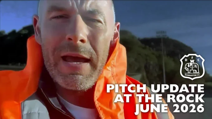 Close-up of a person in an orange jacket providing an update about the pitch at Dumbarton F.C. The club's logo is visible alongside text overlay.