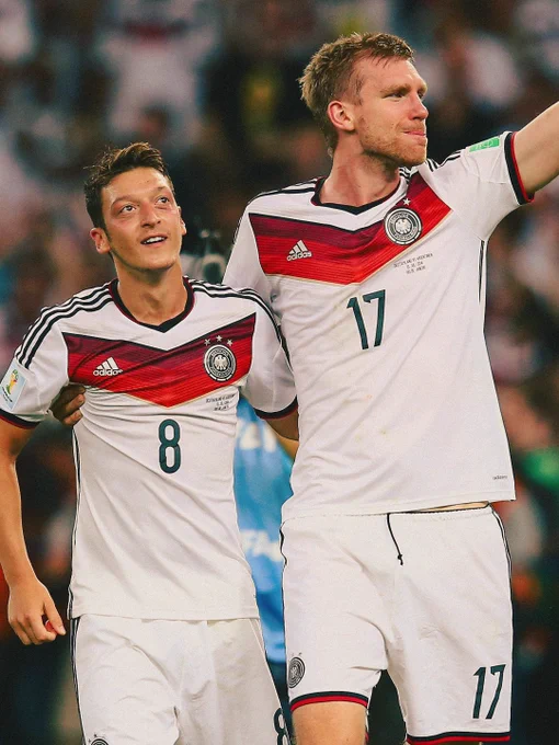 Mesut Ozil and Per Mertesacker in action for Germany.