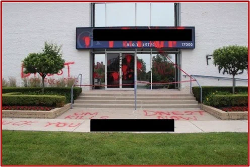 Photo of a building entrance vandalized. 