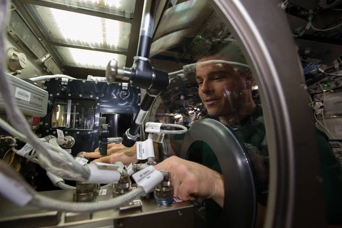 NASA astronaut Reid Wiseman installs Capillary Channel Flow (CCF) experiment hardware in the Microgravity Science Glovebox (MSG) aboard the International Space Station. This investigation studied how fluids move through capillaries in the absence of gravity. Capillary systems don’t require pumps or moving parts and can be used in the design of spacecraft systems.
