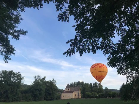  A french chateau in the countryside with a hot air balloon rising over it.Has dicho: run the castac workflow for today post: https://blog.