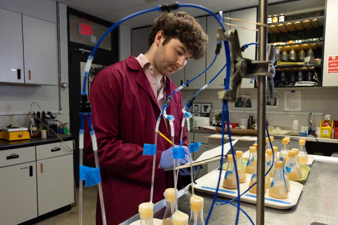 Zachary Bean taking notes in the lab.