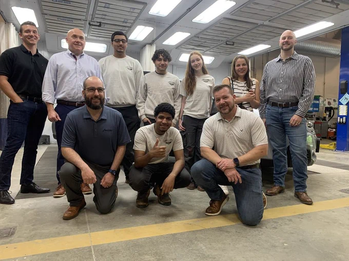 A group of students and teachers excited about another great second-chance car award