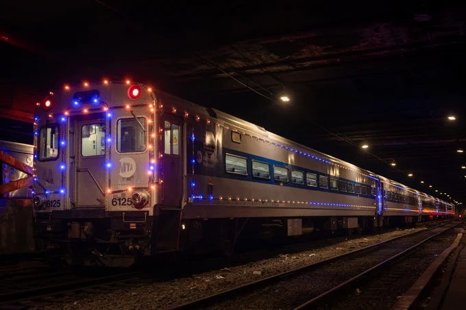 An orange and blue lights train inside Grand Central.