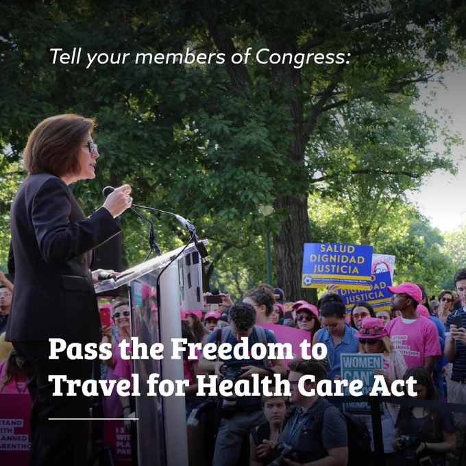 A person speaks at a podium during a reproductive rights rally in a park, addressing a crowd holding signs supporting abortion access and reproductive justice. White text over the image reads, “Tell your members of Congress: Pass the Freedom to Travel for Health Care Act.