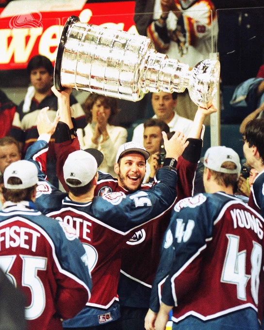 Members of the 1996 Colorado Avalanche celebrating on the ice with the Stanley Cup