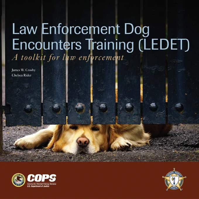 Cover of a law enforcement dog training manual showing a dog lying behind a black metal gate with paws visible on gravel.