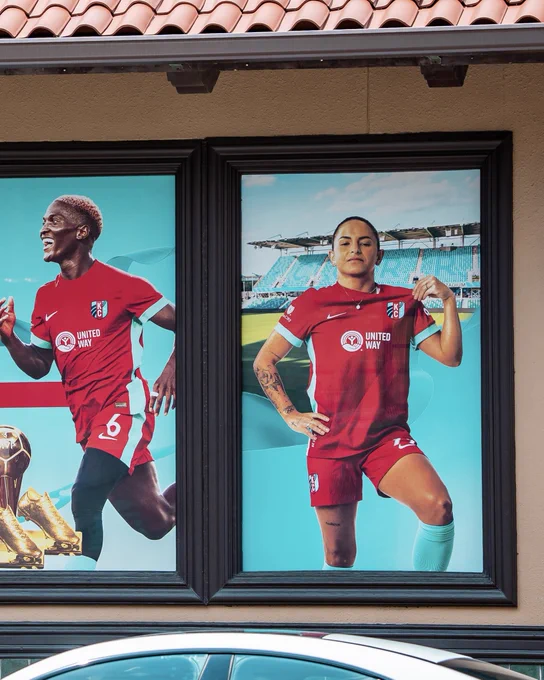 Window signage with a photo of Temwa and Debinha 