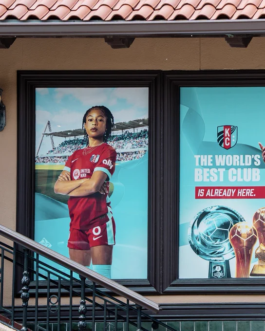 Window art with a photo of Croix Bethune and signage that reads "the world's best club is already here"