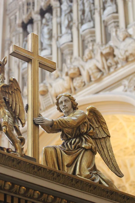 The figure of an angel holding a Christian cross