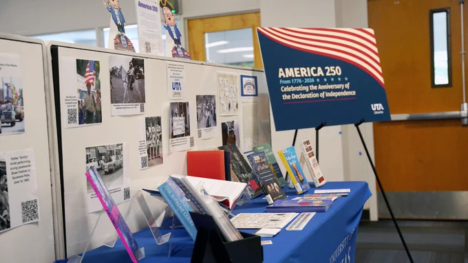 Pictured is a photo of a display American History books on display on a table and a sign that reads "America 250."