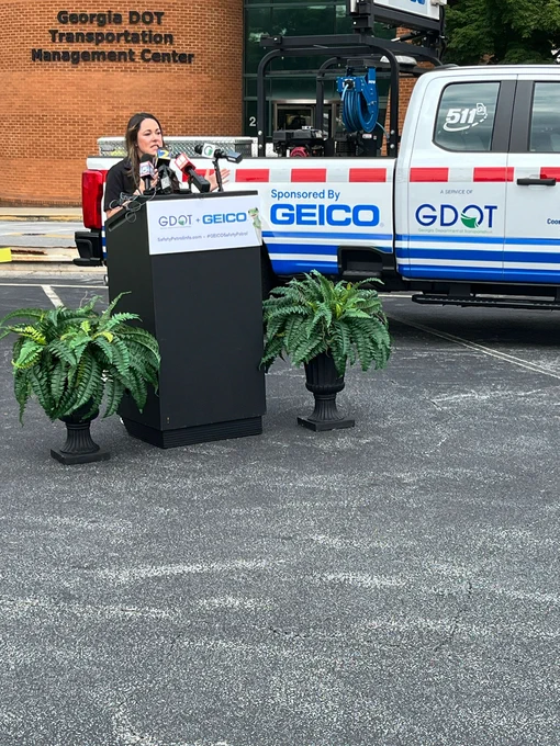Natalie Dale speaking at the press conference announcing the GEICO sponsorship