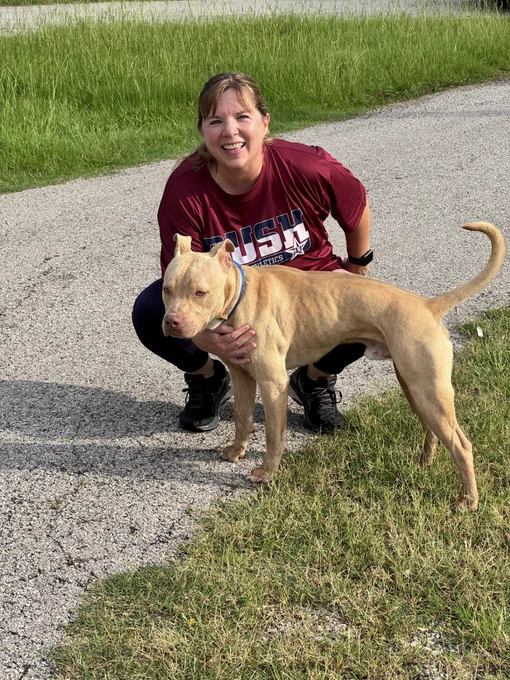 Kathryn with shelter dog at volunteer event.