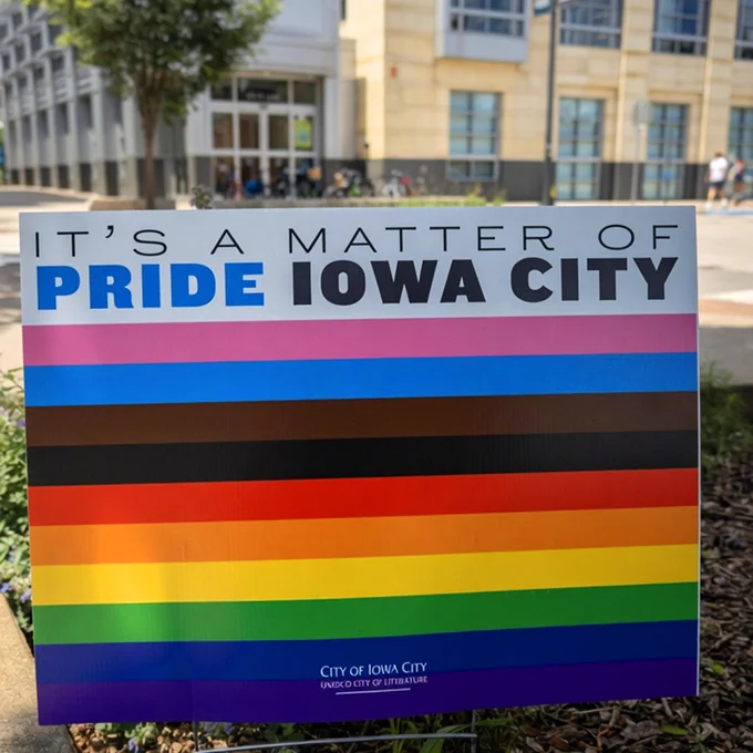 Yard sign that reads "It's a matter of Pride Iowa City" with the Pride flag featured below.