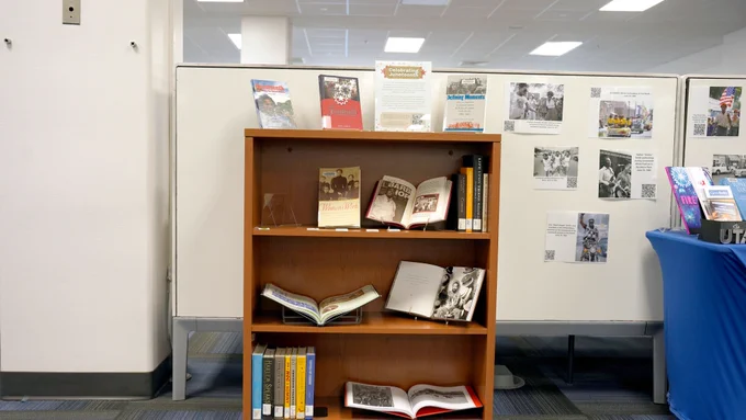 Pictured is a photo a bookcase that has history books on display that talk about the Juneteenth holiday.