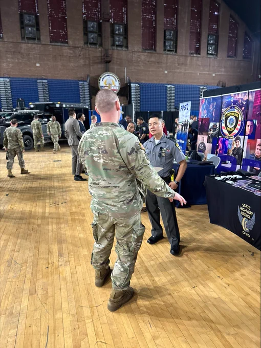 Trooper Pham speaks with soldiers at the District of Columbia National Guard Armory Annual Career Fair for Law Enforcement. 