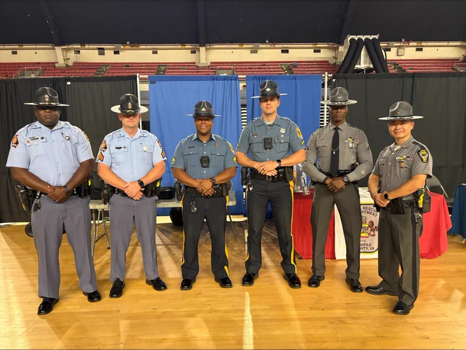 Trooper Lawrence and Trooper Pham (right) join law enforcement officers from throughout the country (left) at the District of Columbia National Guard Armory Annual Career Fair for Law Enforcement. 