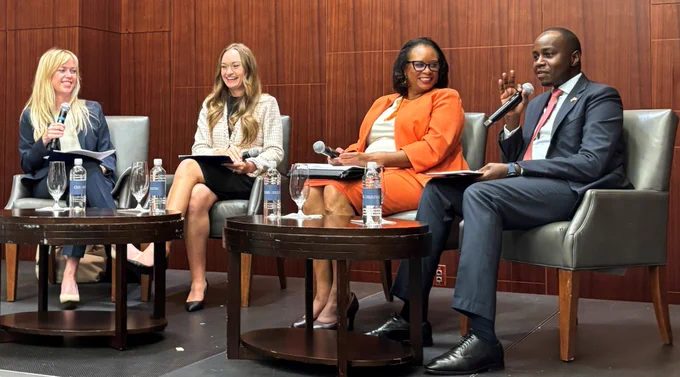 Commercial Officer Ashley Bubna and DAS Sarah Troutman sit in chairs at head of room next to two other panelists and share perspectives.