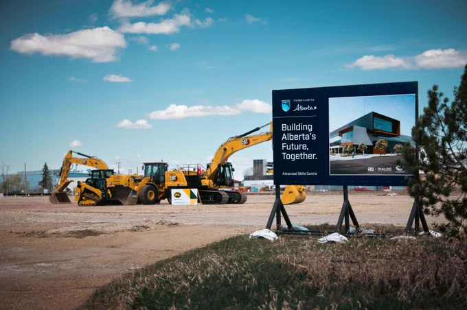 PCL Construction jobsite with excavators and a project sign displaying a rendering of NAIT Advanced Skills Centre in Edmonton, Alberta.