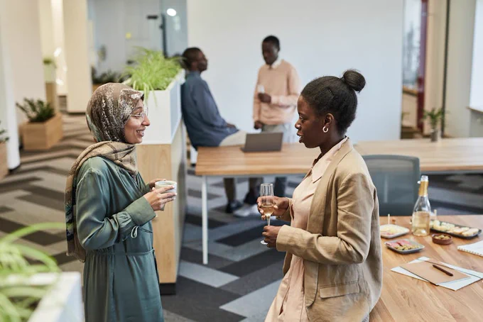 Group of diverse professionals networking in a modern office setting.