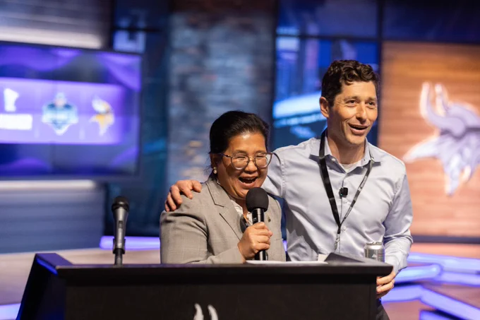 Saint Paul Mayor Kaohly Her and Minneapolis Mayor Jacob Frey share a lighthearted moment during the Minnesota Sports and Events partner celebration.