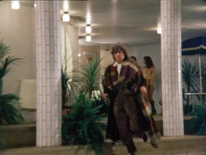 The Doctor, Leela and Andred by an indoor pool
