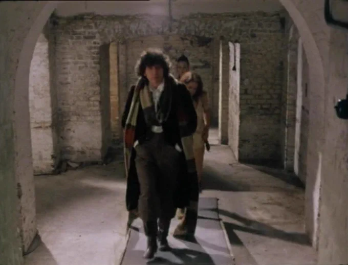 The Doctor, Leela and Rodan in a corridor