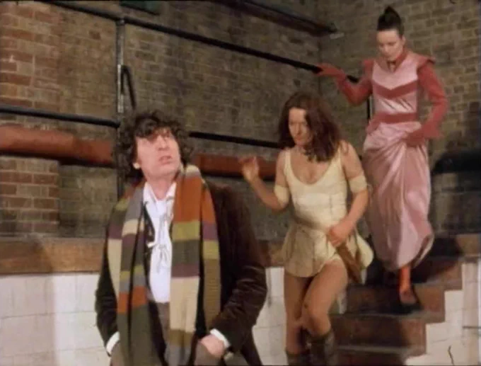The Doctor, Leela and Rodan by a staircase