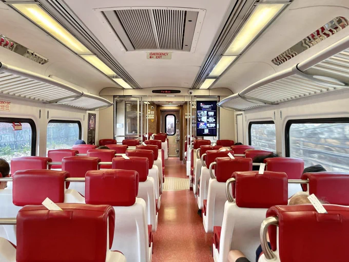The interior of a Metro-North New Haven Line train with people seated.