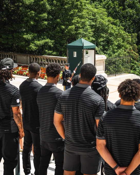 Photo of the Commanders 2026 rookie class at Arlington National Cemetery. They are witnessing a changing of the guard at the Tomb of the Unknown Soldier.