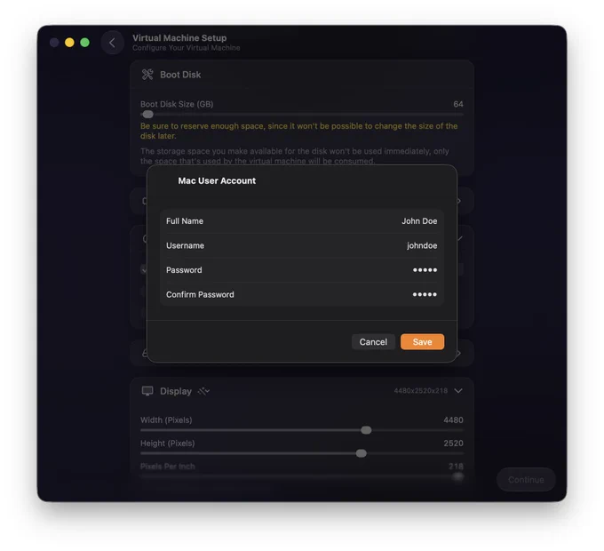 A dark-themed virtual machine setup window shows a section for configuring a Mac user account. The pop-up form displays fields for Full Name set to “John Doe,” Username set to “johndoe,” and Password and Confirm Password fields filled with masked dots. At the bottom, there are two buttons: a gray “Cancel” button and an orange “Save” button. Behind it, part of the Boot Disk settings and Display configuration sliders are visible.
