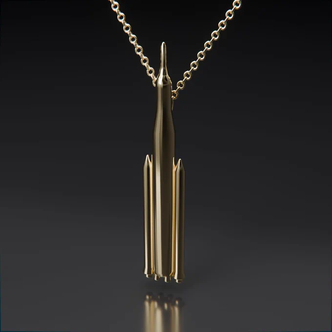 Minimalist sleek pendant necklace of the SLS rocket on a gold chain.