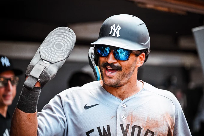 Trent Grisham celebrates in the dugout after scoring.