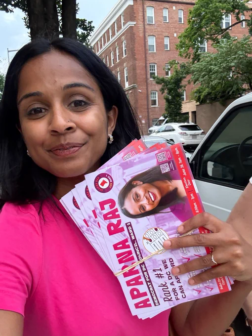 Selfie of Aparna canvassing in  Columbia Heights, with lit that reads “Aparna Raj, Democrat for DC Council, Ward 1”