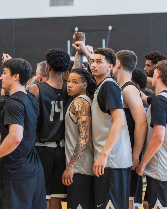 team huddle with hands in after practice