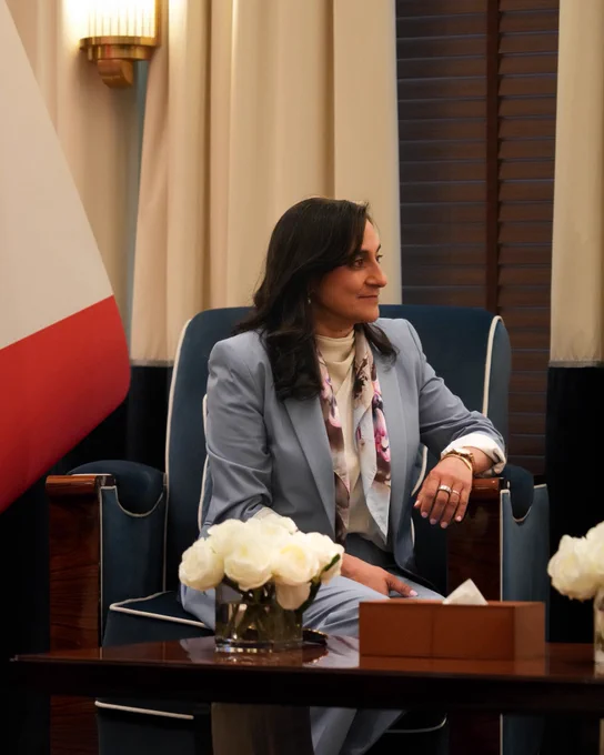 Minister Anand seated during a meeting with His Excellency Dr. Abdullatif bin Rashid Al Zayani, Minister of Foreign Affairs of the Kingdom of Bahrain, with a Canadian flag in the background.