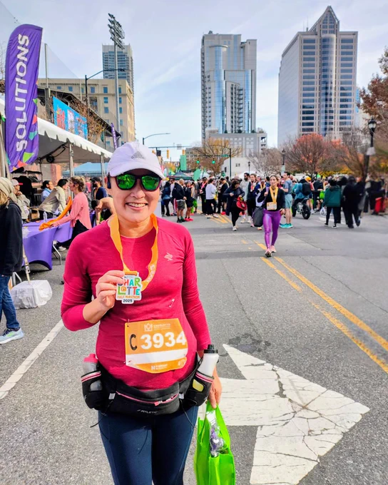 Dr. Lanna Kwon poses with her finisher's medal at the Charlotte Half Marathon