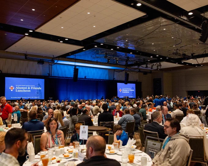 A large gathering of attendees at the Alumni & Friends Luncheon held by Southern Baptist Theological Seminary in a spacious hall.