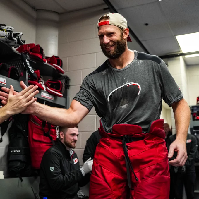 Photo of Jordan Staal celebrating with his teammates in the locker room