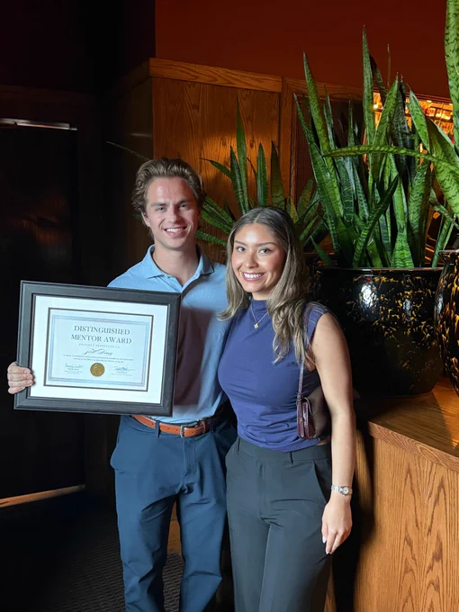 Scott Davey stands with his student mentee after receiving the Distinguished Mentor Award for the BBA Data Analytics mentorship program.