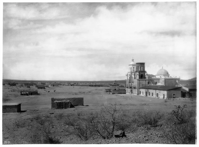 "Mission San Xavier del Bac, showing small Indian structures, Tucson, Arizona, ca.1898-1900. Photographer: Pierce, C.C. (Charles C.), 1861-1946."

