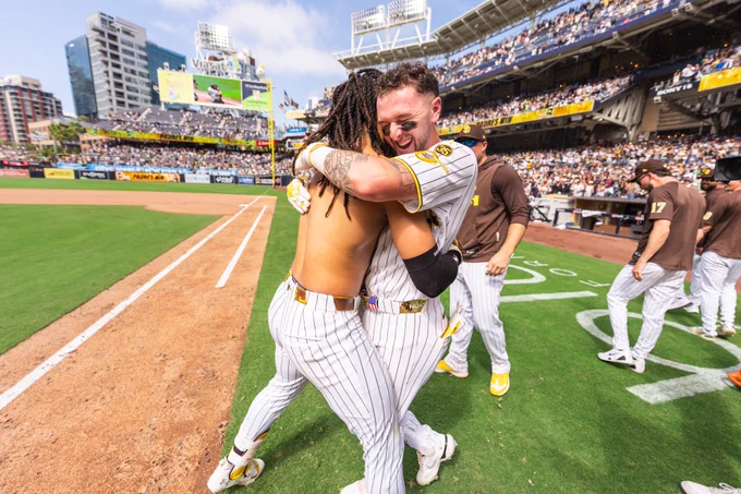 Photo of Fernando Tatis Jr. and Jackson Merrill hugging after Fernando's walk-off home run.
