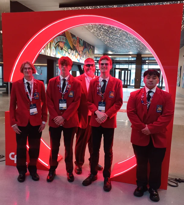 Students pose for picture in Red SkillsUSA jackets