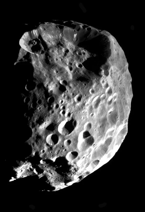 Phoebe appears as a crater-pocked body in the blackness of space in this image taken on June 11, 2004. Credit: NASA/JPL