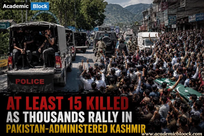 Large crowd of protesters marching in Pakistan-administered Kashmir with visible tension and security forces present