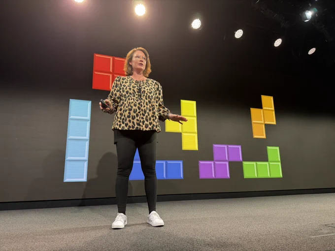 Robin presenting in front of Tetris blocks.