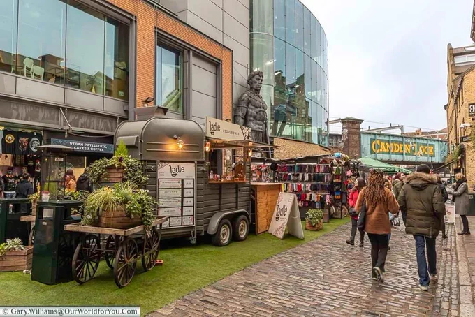 Camden Lock Place in Camden Market with it's mix of food stalls and fashion leading towards the Camden Lock railway bridge.